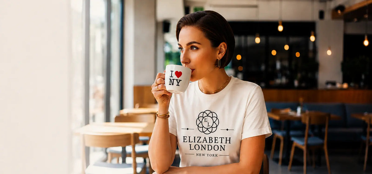 Elizabeth London woman wearing a branded T-shirt and holding an I Love New York mug